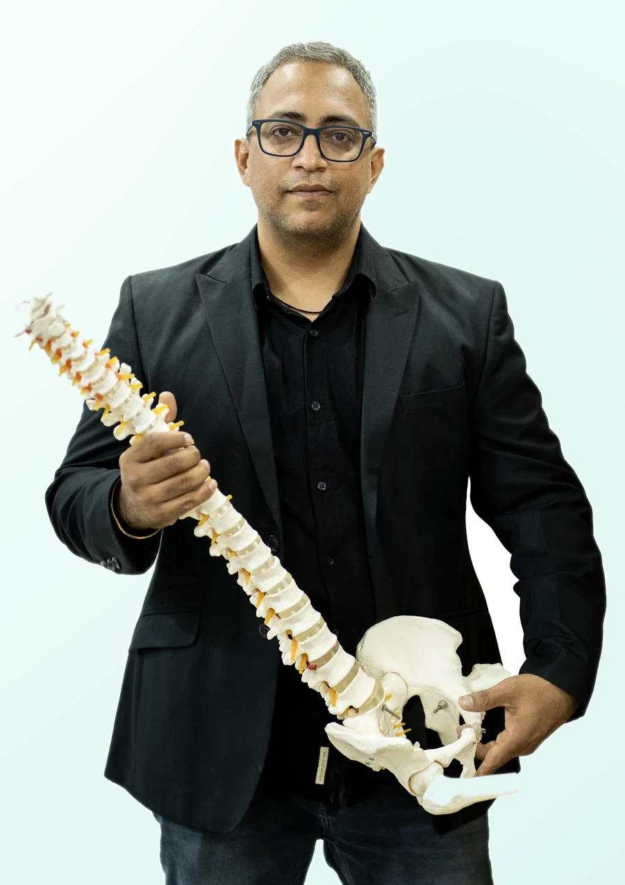 Dr. Harish Tahiliani holding a spine model